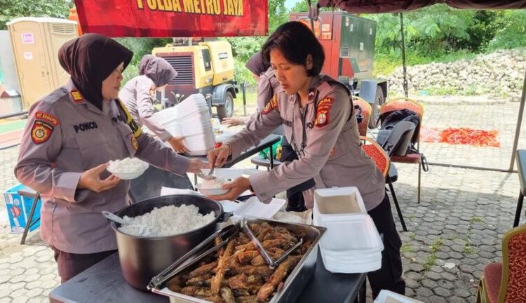 Polwan Polda Metro Bagikan Makanan untuk Korban Kebakaran Depo Plumpang